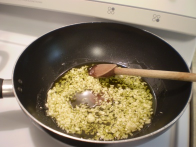 Minced garlic gently cooking in olive oil.